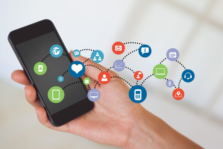 Hand holding smartphone with apps